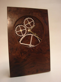 Moving Gear Clock 7.5"w x 11.5"h x 3" d. Secondary mechanism drives the gears which turn at the same rate as the second hand. Walnut and Walnut Burl.